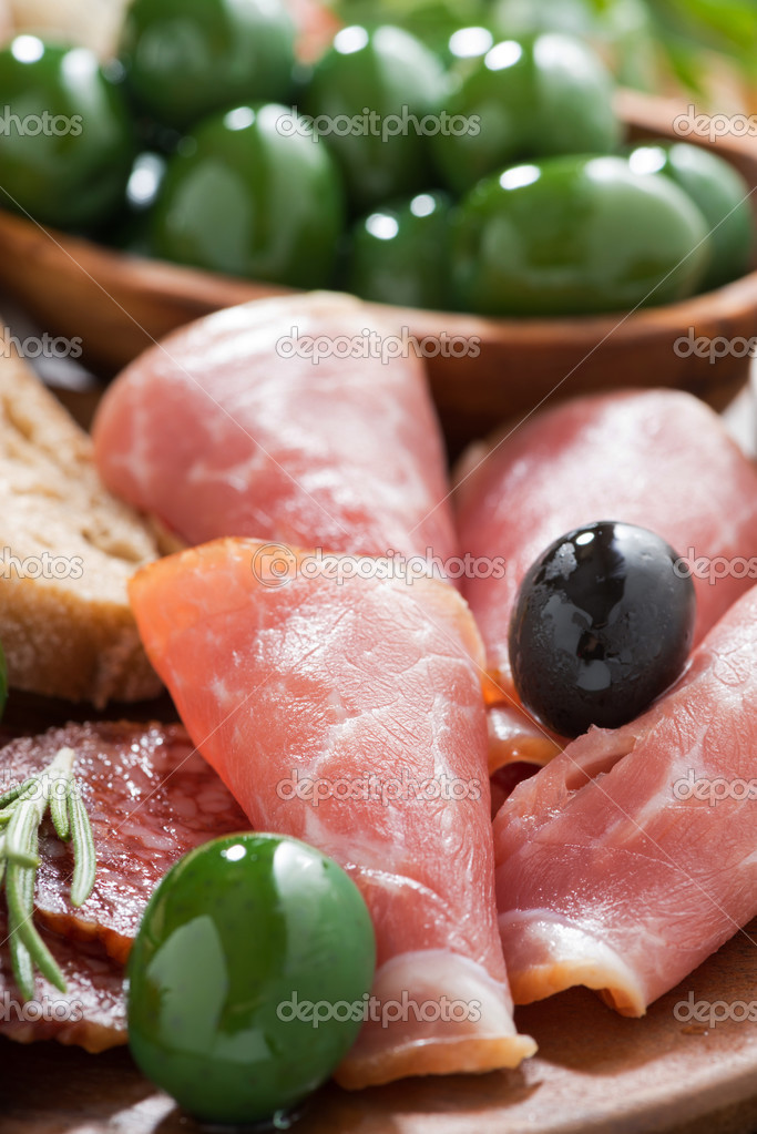Assorted Italian antipasti deli meats, olives and ciabatta Stock