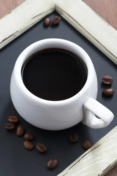 Taza de café en pizarra negra de cerca, vista superior — Foto de Stock
