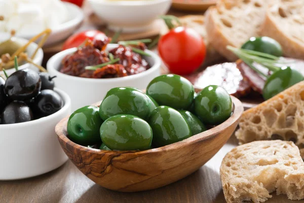Assorted Italian antipasti - olives, pickles and bread — Stock Photo, Image