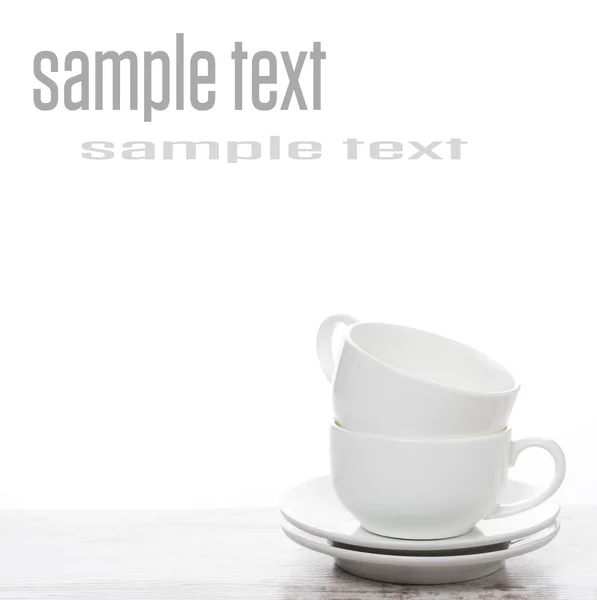 Empty coffee cups on a white table and space for text — Stock Photo, Image
