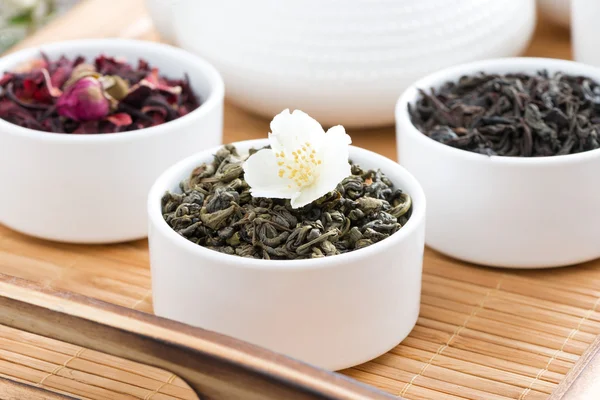 Dry herbal teas in white bowls on a tray — Stock Photo, Image