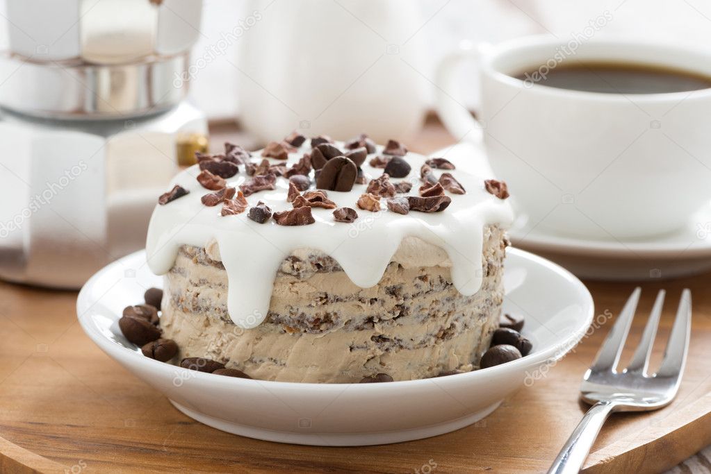 chocolate coffee cake with icing on a plate, horizontal