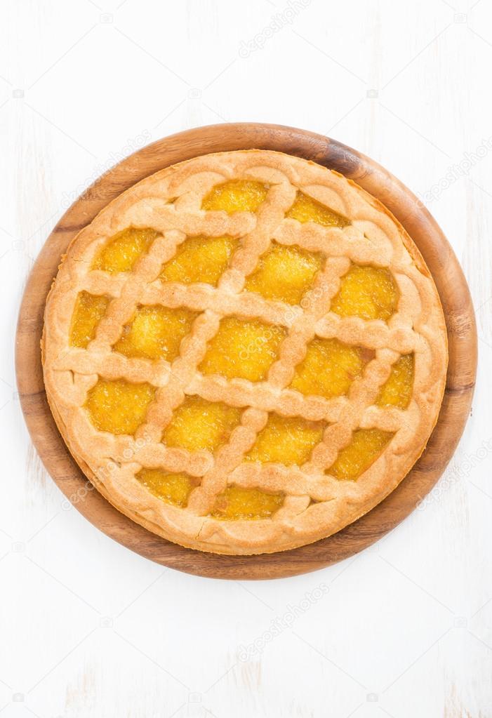 pie with fruit filling on a white wooden background, top view