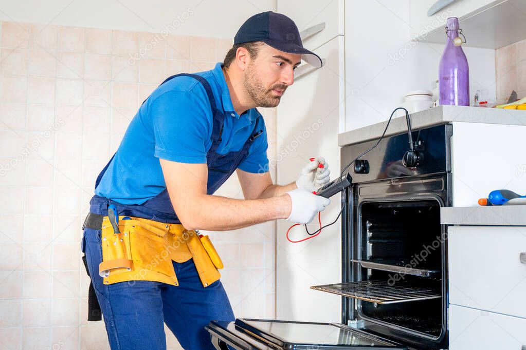 One repairman fixing malfunctioning kitchen oven problem