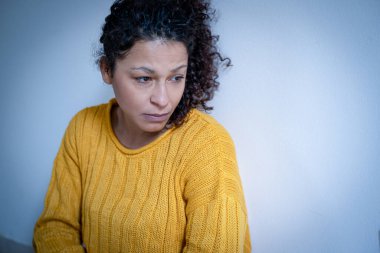 Black woman feeling negative emotions isolated on white wall