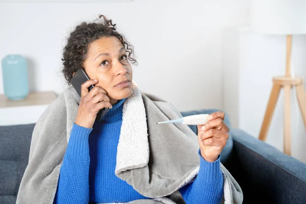 Black Woman Calling Doctor Home Feeling Sick — Stockfoto