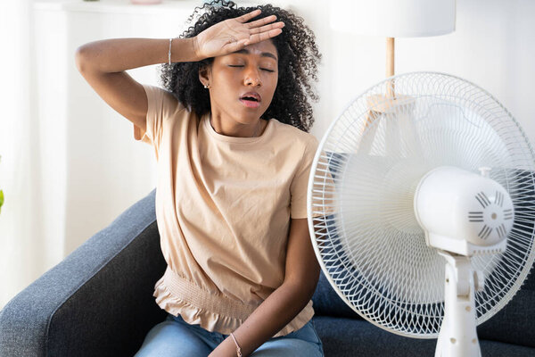One black woman with fan feel very hot