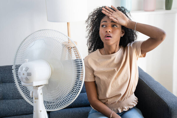 Black woman at home refreshing during summer haze