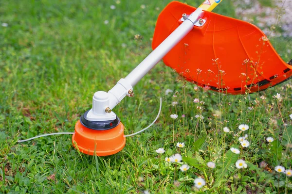 Close up on string trimmer head weed brush cutter