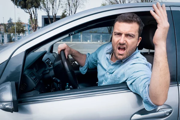 Road rage man at the wheel threatening other drivers