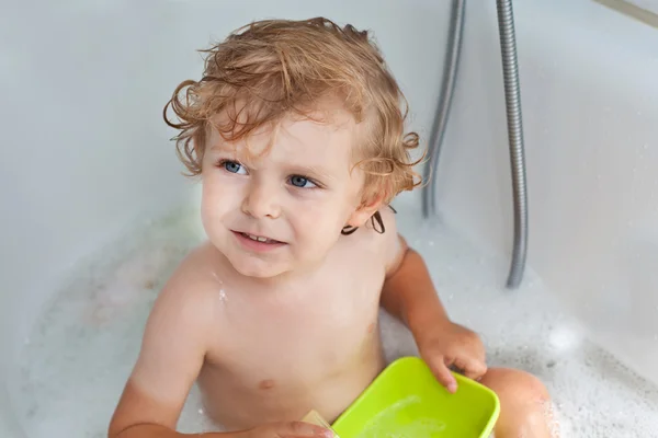 Lovely little boy with blond hairs taking bath Stock Picture