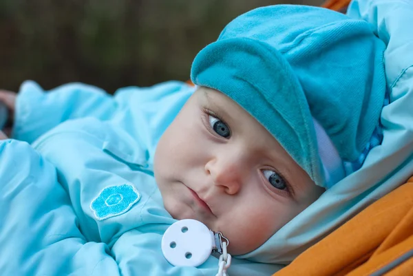 Dorable baby boy in blue clothes and with blue eyes Royalty Free Stock Images