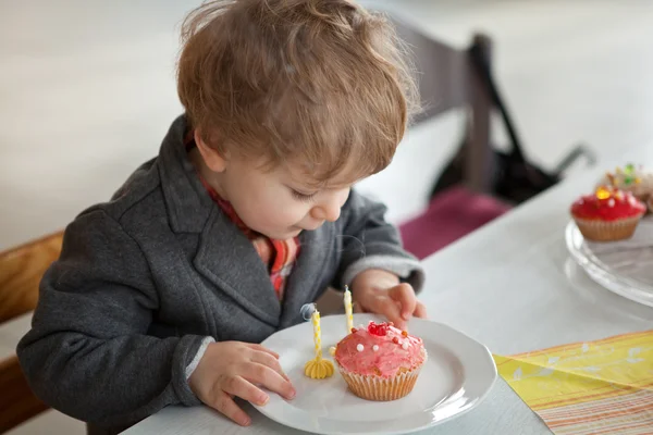 Little toddler blowing two birthday candles — Stock Photo, Image