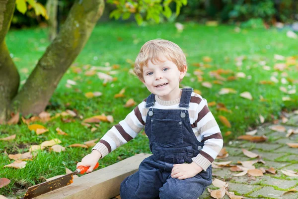 Little toddler boy playing in autumn garden — Stock Photo, Image