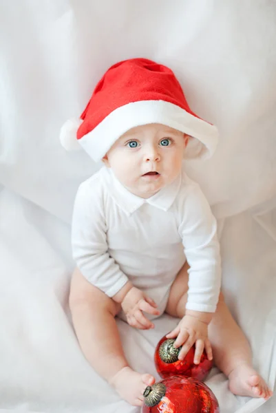 Baby boy with Christmas cap and balls — Stock Photo, Image