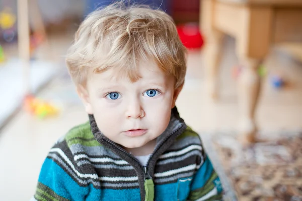 Adorabile bambino con gli occhi azzurri al coperto — Foto Stock