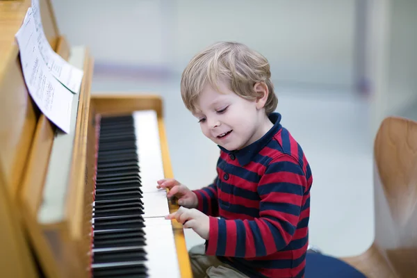 Two years old toddler boy playing piano — Stock Photo, Image