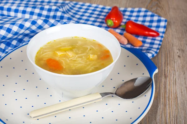 Noodle soup with carrots and vegetables in white bowl — Stock Photo, Image