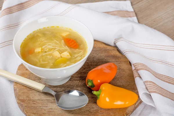 Noodle soup with carrots and vegetables in white bowl — Stock Photo, Image