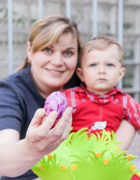 Mother and little toddler son on Easter with focus on egg — Stock Photo, Image
