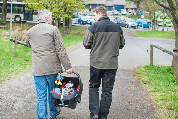 Grandfather and Father walking with little baby son — Stock Photo, Image