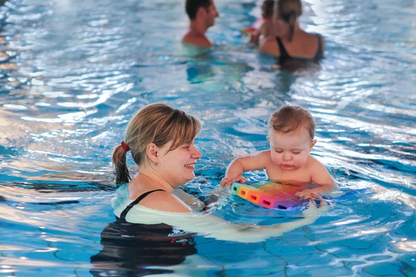 Little baby with blue eyes learning to swim — Stock Photo, Image