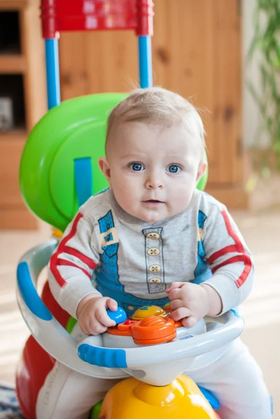 Little baby boy in blue big toy car indoor — Stock Photo, Image