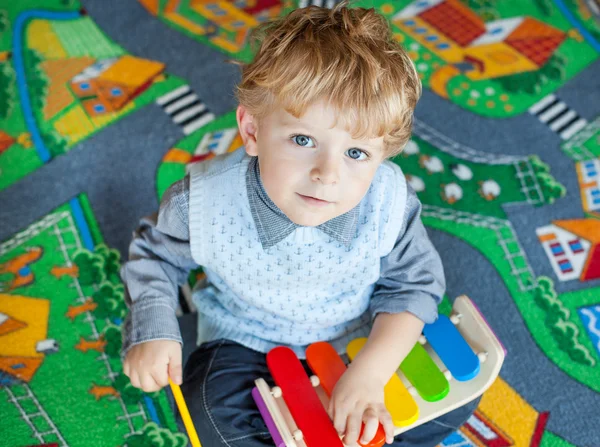 yürümeye başlayan çocuk ahşap müzik oyuncakla oynamak