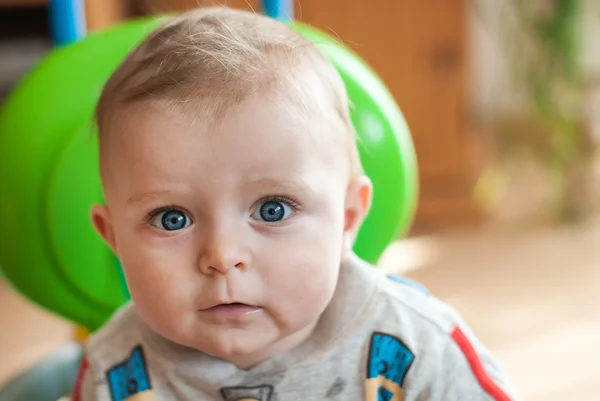 Little baby boy in blue big toy car indoor — Stock Photo, Image