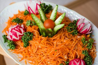 Carrot salad decorated with vegetables clipart