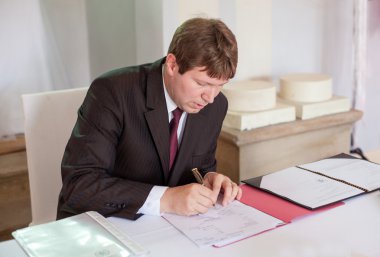 Marriage celebrant preparing documents for wedding clipart