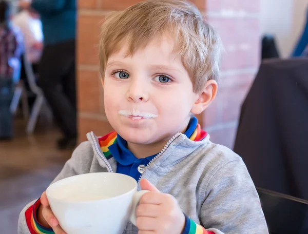 Little toddler boy drinking cup of milk — Stock Photo, Image