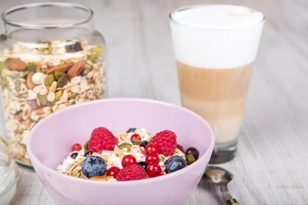 Healthy breakfast with muesli, milk, berries and coffee