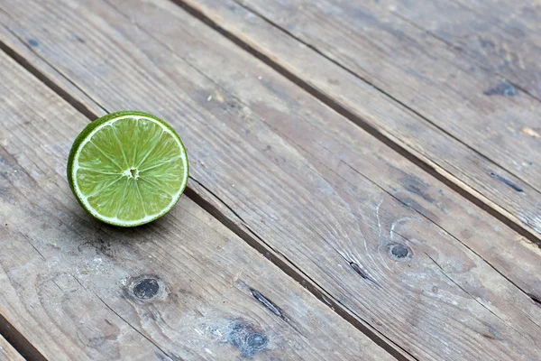 Fresh ripe lime on wooden background — Stock Photo, Image