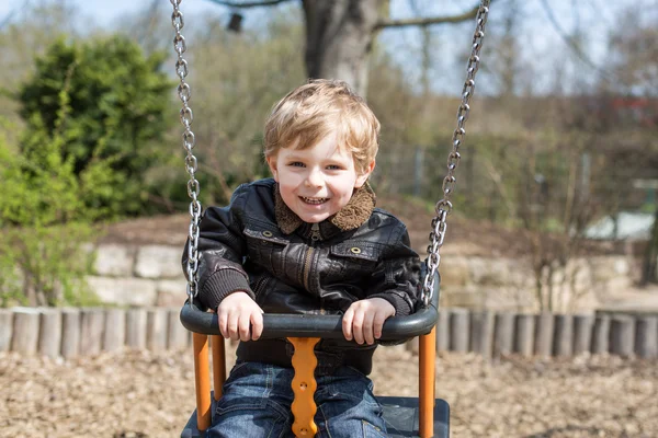 Beautiful toddler boy having fun on swing — Stock Photo, Image