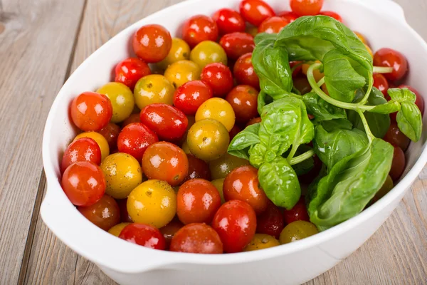 Fresh ripe tomatoes in white casserole — Stock Photo, Image