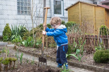 küçük bir çocuk ve babası sebze dikimi tohumları