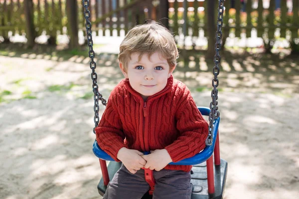 Beautiful toddler boy having fun on swing — Stock Photo, Image