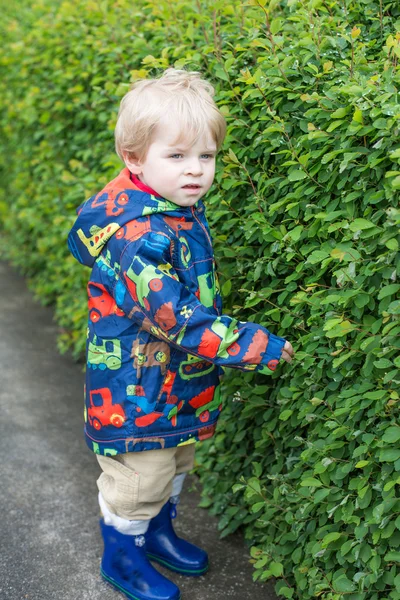 Little toddler boy in rain clothes, outdoors — Stock Photo, Image