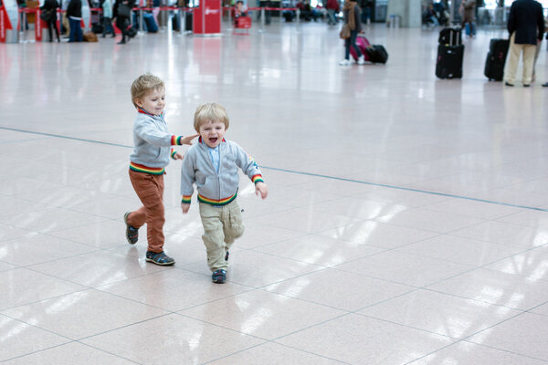 Two little toddler boys playing at the airport