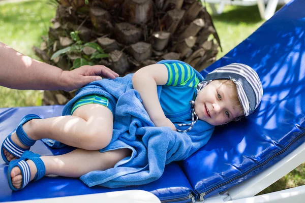 Little blonde toddler boy in swimm suit on couch — Stock Photo, Image