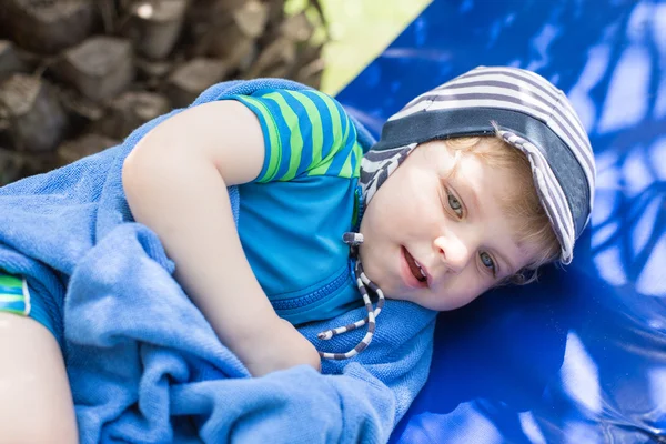 Little blonde toddler boy in swimm suit on couch — Stock Photo, Image