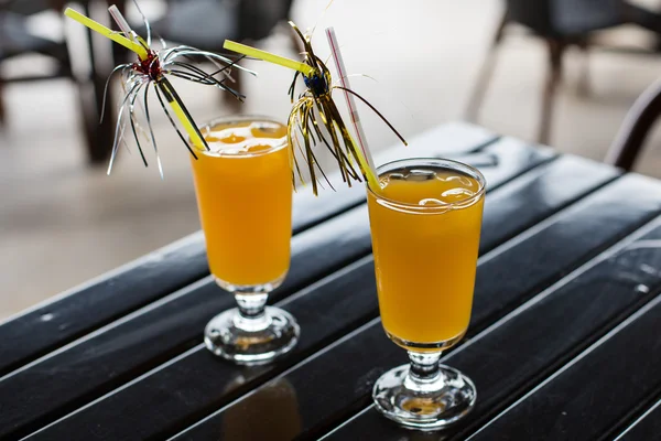 Geel cocktail met stro op houten tafel — Stockfoto