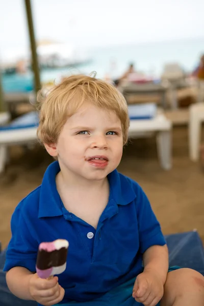 Little blond toddler eating chocolate ice cream — Stock Photo, Image