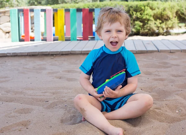 蹒跚学步的小孩玩沙子和玩具 — 图库照片