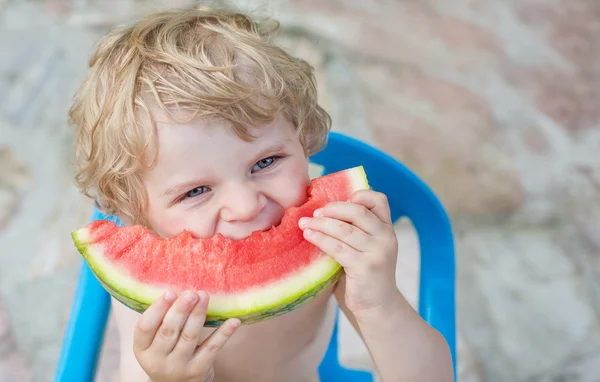 スイカを食べるブロンドの毛で愛らしい小さな幼児男の子 — ストック写真