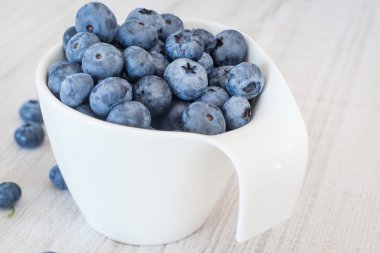 Olgun taze yaban mersini ile beyaz kase Kupası