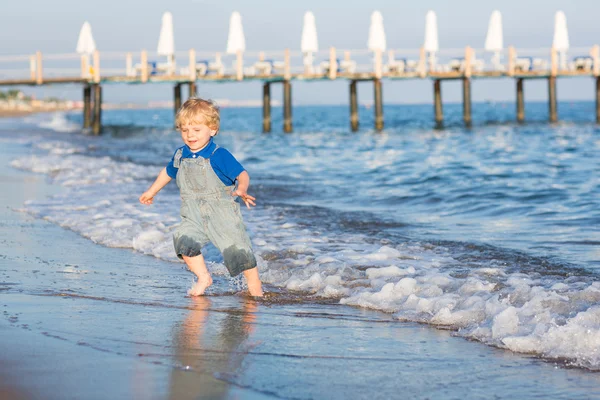 Little toddler boy having fun on the beach in summer — Zdjęcie stockowe