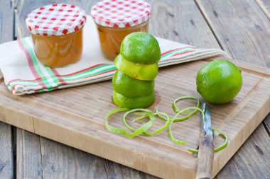 Homemade lime jam with fresh limes clipart