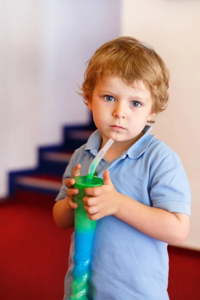 Kleiner Junge trinkt buntes gefrorenes Schneematsch-Eis — Stockfoto